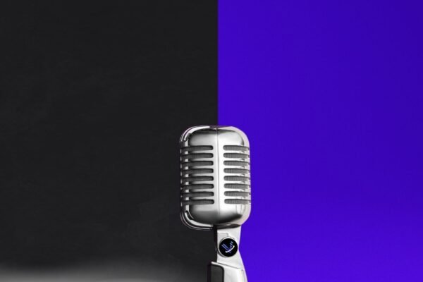 Microphone with Voice 360 logo in front of black and purple background.